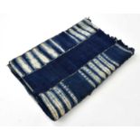 A mid century dyed and stitched blue textile panel, formed of six blue strips and five partially