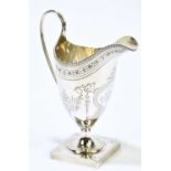 PETER & ANN BATEMAN; a George III hallmarked silver helmet shaped cream jug, with engraved cartouche