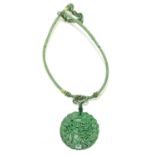 A Chinese carved green hard stone pendant, diameter 5cm.