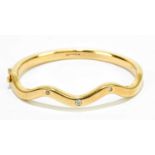 A 9ct gold serpentine hinged bangle, set with three diamonds, gross weight 41.5g