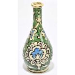 A Persian Iznik type vase, decorated with flowers against a green ground, unsigned, height 21cm.