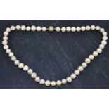 A string of hand tied baroque pearls, length approx. 53cm, with Langer patent silver magnetic clasp,