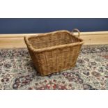 A large wicker log basket, length 61cm.