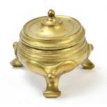 A 19th century Chinese turned bronze circular box and cover raised on three swept supports, diameter