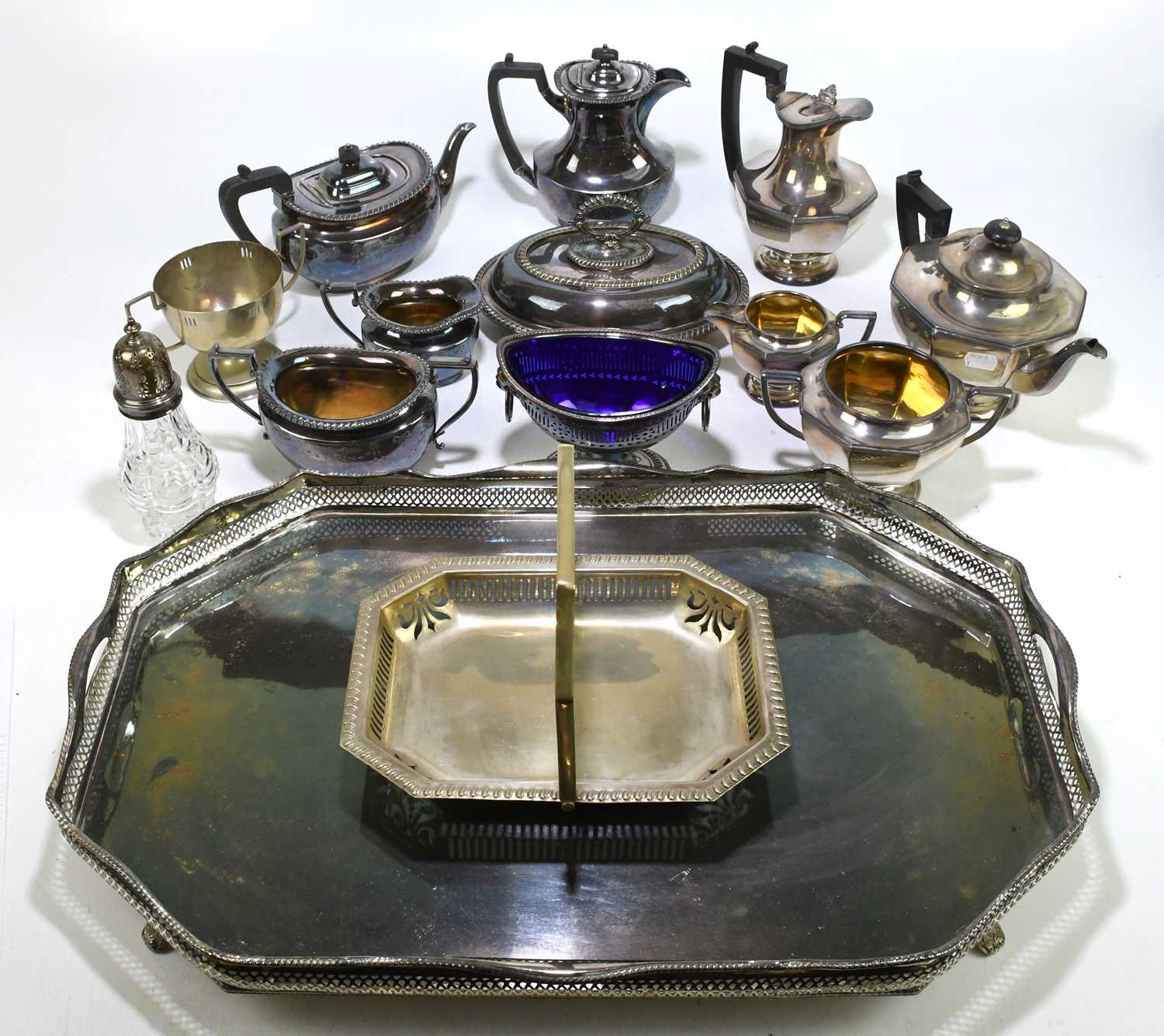 A pierced silver plated twin handled galleried tray, length 60cm, with an Art Deco four piece silver