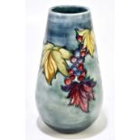 MOORCROFT; a 'Leaf and Berry' pattern vase, with mottled blue green ground, impressed mark and