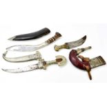 A horn handled jambiya, a further cased Eastern curved sword, and a kukri knife in scabbard (3)
