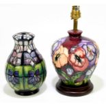 MOORCROFT; a baluster shaped table lamp in the 'Violet' pattern, height 18cm, together with a