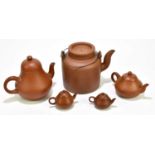 Five Chinese redware Yixing teapots and covers, the tallest a cylindrical example height 15.5cm (5)