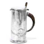 ARCHIBALD KNOX FOR ENGLISH PEWTER; a Liberty & Co pewter lidded hot water jug, with wicker handle