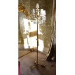 A modern brass five arm standard lamp with crystal drops on three splayed feet, height 185cm.