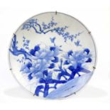 A large early 20th century Japanese blue and white charger, decorated with peony and rockworks,