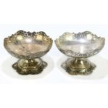 A pair of Persian white metal comports with niello and pierced decoration, height 13cm, diameter