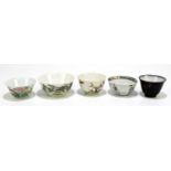 Five Chinese porcelain tea bowls, to include a Famille Noire example, decorated in gilt to the