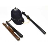 A police helmet, together with three truncheons, length of largest 56cm.