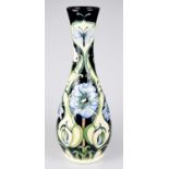 RACHEL BISHOP FOR MOORCROFT; a large vase decorated with blue flowers against a green / cream