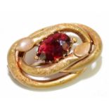 A Victorian gilt metal brooch, set with a red glass 'gem', length 3.5cm.