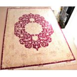 AMINIAN PERSIAN CARPETS; an Iranian handmade rug with red floral centre medallion within a beige and