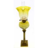 A Victorian brass oil lamp, the vaseline and clear coloured shade with etched decoration above the