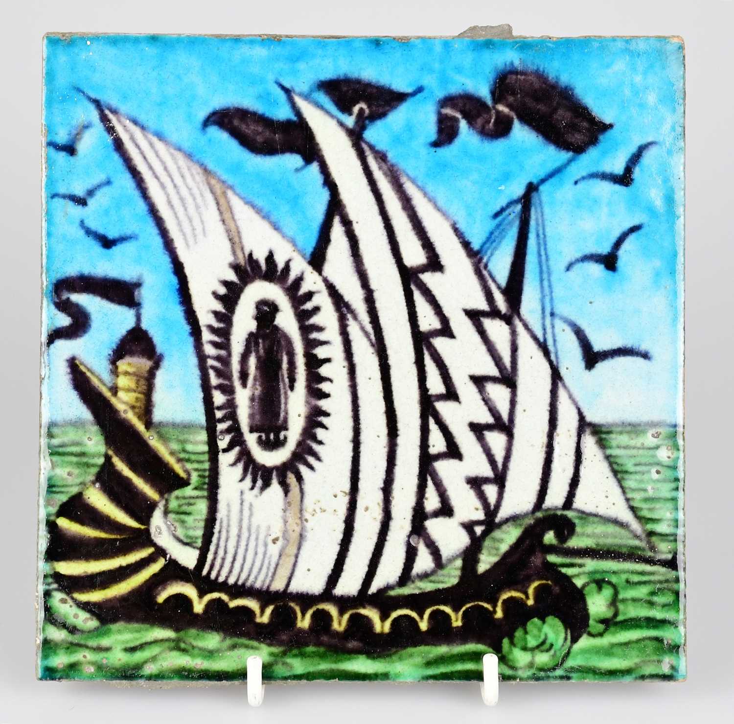 WILLIAM DE MORGAN; an Art Pottery tile painted with a two masted ship in shades of black, white,