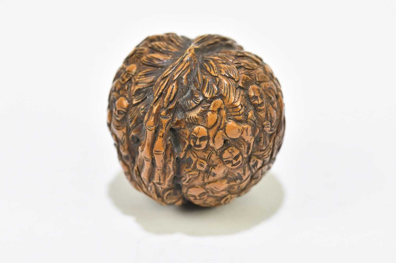 A Japanese carved walnut, decorated with figures within floral detail, height 3cm. - Image 4 of 4