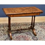 A Victorian walnut fold over swivel top card table of rectangular form on fluted columns, width
