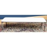 SOVET; an opaque glass and chrome rectangular coffee table, with rounded corners, on triform legs,