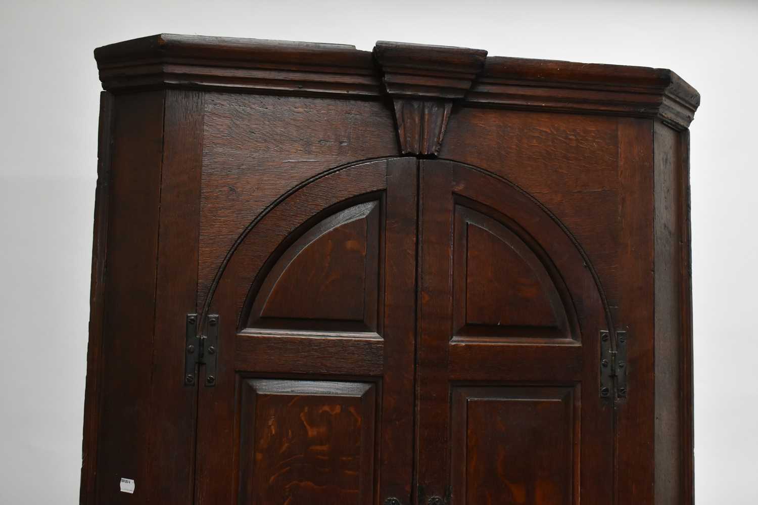 A Georgian oak freestanding corner cupboard with moulded cornice above a pair of arch shaped - Image 3 of 4