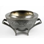 ARCHIBALD KNOX FOR LIBERTY & CO; an English Pewter twin handled footed bowl with embossed stylised