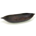 PAPUA NEW GUINEA; an unusual carved wooden boat shaped bowl, length 61cm.