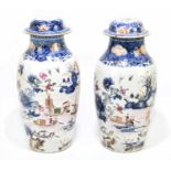 A pair of late 18th century Chinese Famille Rose lidded vases, each decorated in enamels with