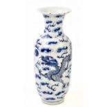 A late 19th century Chinese blue and white porcelain vase with flared neck, decorated with a four