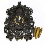 A late 19th century Black Forest cuckoo clock, ornately carved with stags' heads and floral