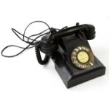 A vintage bakelite telephone, AEP, with brass dial