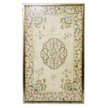 An Eastern needlework panel with floral decoration on a cream ground, 55 x 33cm, framed and glazed.