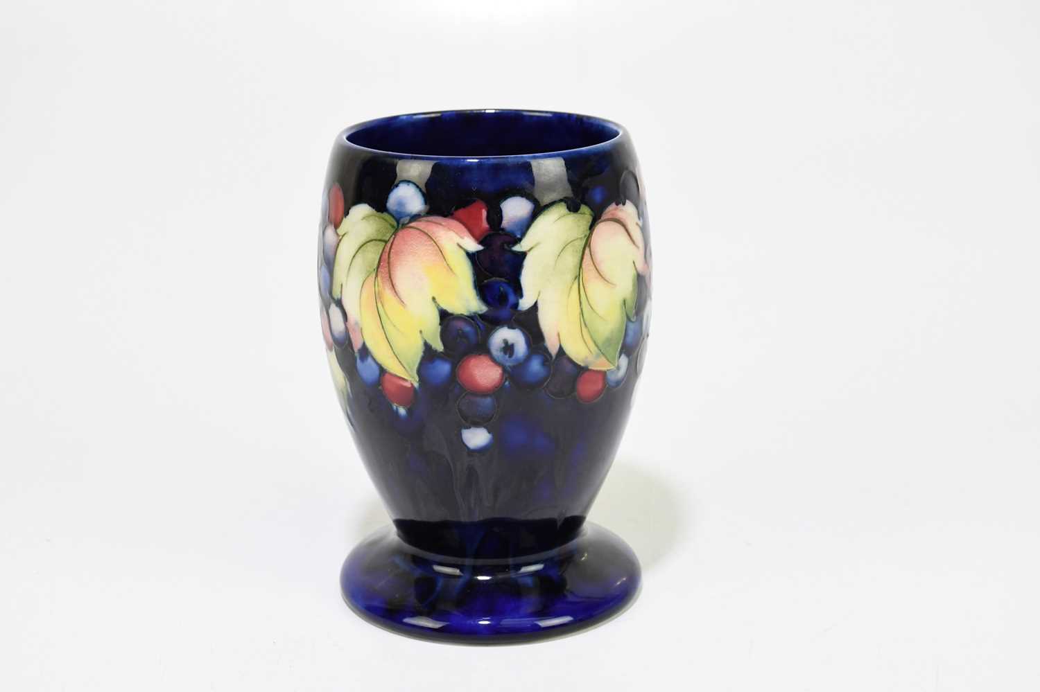 MOORCROFT; a 'Leaf and Berry' pattern vase, with a blue ground, impressed marks and painted Walter - Image 2 of 5