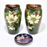 WATCOMBE; a pair of vases decorated with flowers, together with a Moorcroft pin dish, height of