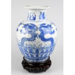 A Chinese blue and white porcelain vase decorated with five claw dragons and stylised fruit and