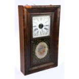 An American walnut wall clock with painted dial and reverse painted door, with original label