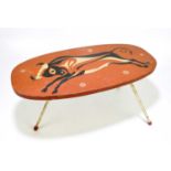 A 1960s small oval table decorated with a bull, on white painted metal legs, height 26cm, length