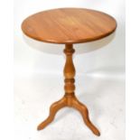 ERCOL; a light elm tripod table, height 75cm.