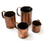 A set of four copper measuring cups, height of largest 16cm.