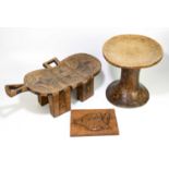 TRIBAL ART; a carved soft wood circular stool with carved detailing, height 34cm, diameter 34cm,