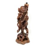 A Japanese carved hard wood lamp, modelled as an elderly gentleman with a bird, on shaped base,