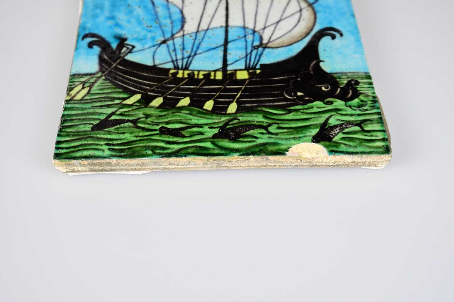 WILLIAM DE MORGAN; an Art Pottery tile painted with a galleon ship with six sailors with paddles - Image 3 of 6