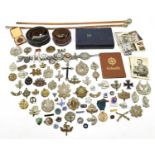 A collection of assorted military and other ephemera, cap badges and militaria, also two swagger