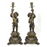 Pair of 19th century bronze candle holders representing cherubs supporting shaped branches with