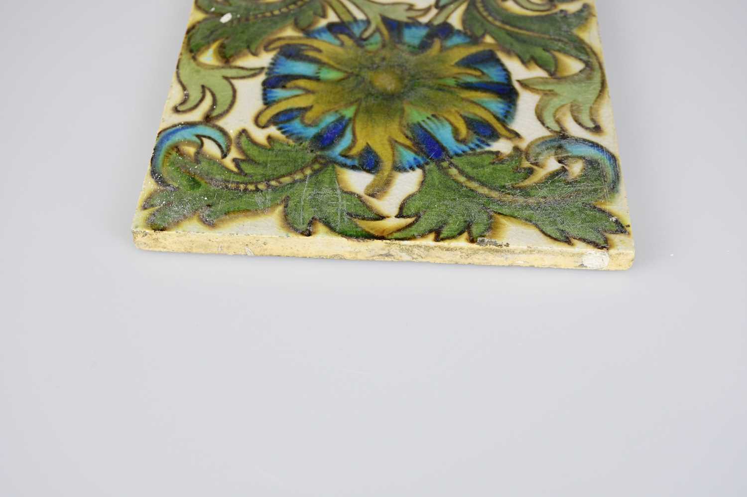 ATTRIBUTED TO MAW & CO; an Art Pottery tile painted with floral decoration, in shades of green, - Image 5 of 6