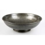 TUDRIC PEWTER; a footed pewter bowl with planished decoration, impressed marks and numbered 01248,