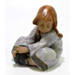 LLADRO; a figure of a kneeling girl, number 2210, height 17.5cm.Condition Report: Good condition.